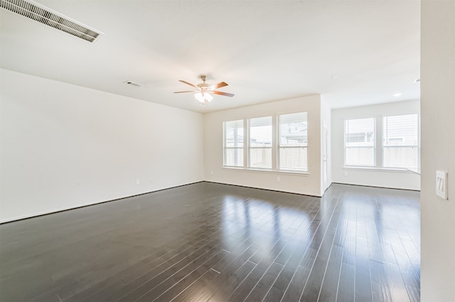 unfurnished room featuring ceiling fan and dark wood-type flooring