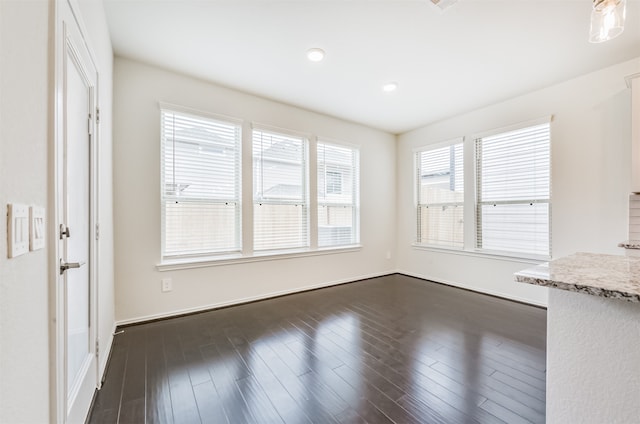 unfurnished living room featuring dark hardwood / wood-style flooring