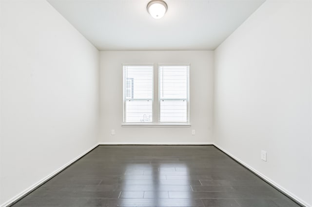 spare room with dark hardwood / wood-style flooring