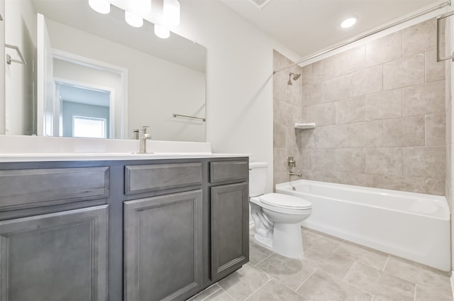 full bathroom with tiled shower / bath combo, vanity, and toilet