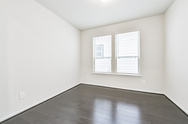 spare room with dark hardwood / wood-style floors