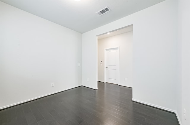 empty room with dark hardwood / wood-style floors