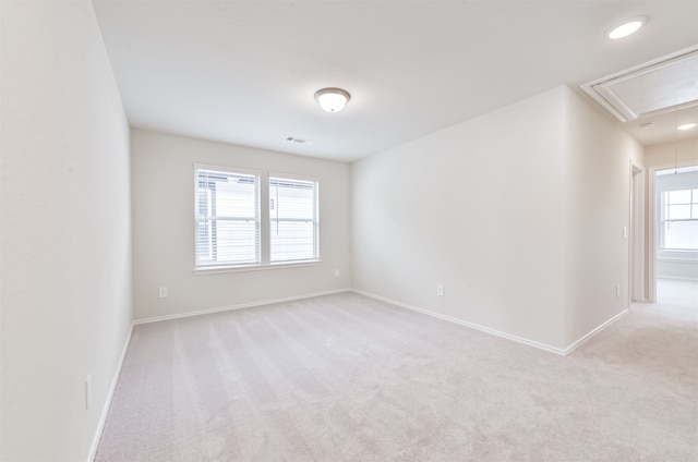 carpeted spare room with a healthy amount of sunlight