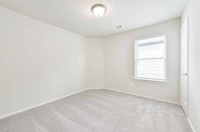 unfurnished room with light carpet