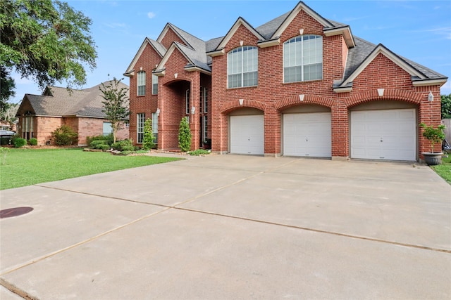 view of front of home featuring a garage and a front yard