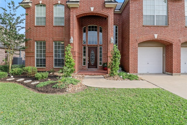 exterior space with a yard, a garage, and central AC unit