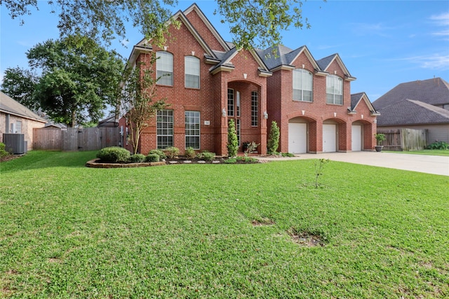 front of property featuring a garage, a front lawn, and central AC