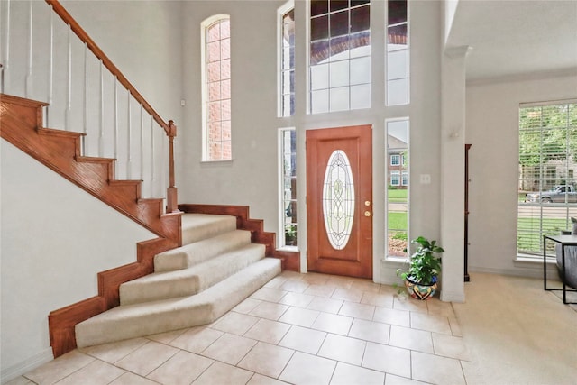 tiled foyer featuring a high ceiling