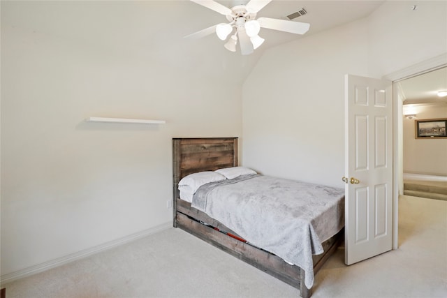 carpeted bedroom with vaulted ceiling and ceiling fan