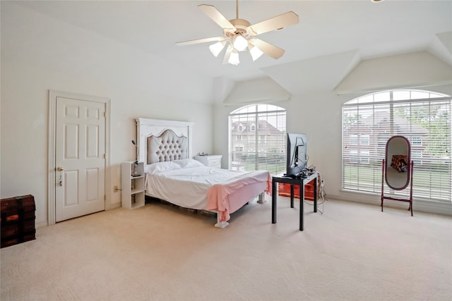 carpeted bedroom featuring vaulted ceiling, multiple windows, and ceiling fan