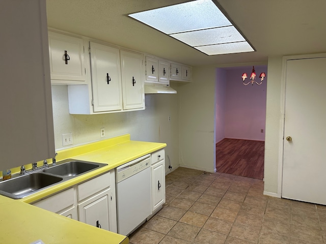 kitchen featuring white cabinets, white dishwasher, light tile patterned floors, and sink