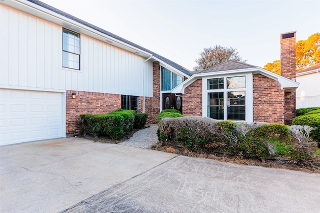 view of side of home featuring a garage