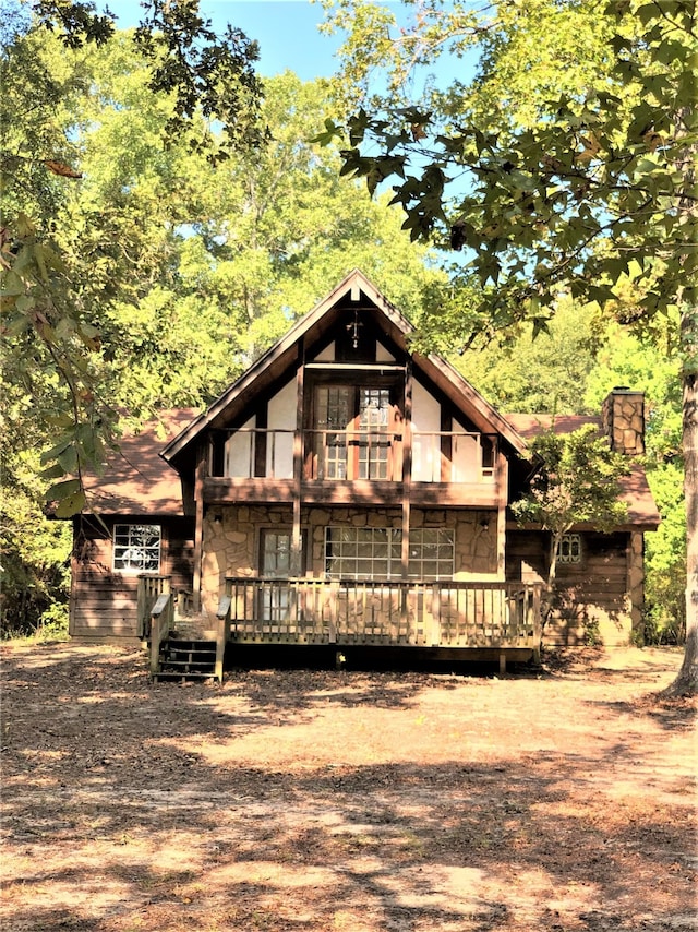 back of house featuring a deck