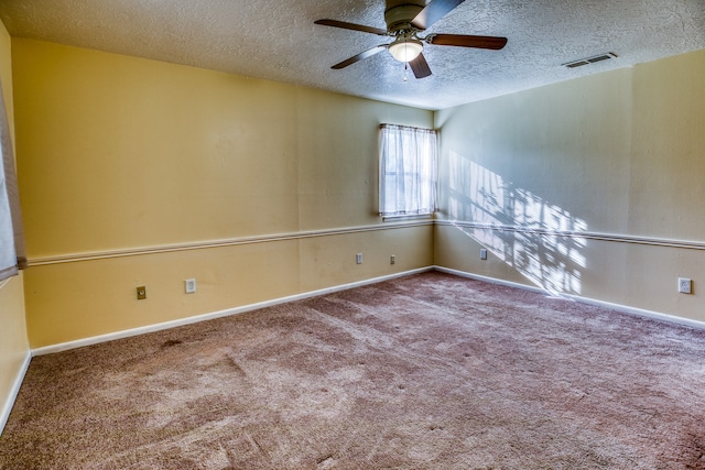 carpeted empty room with a textured ceiling and ceiling fan