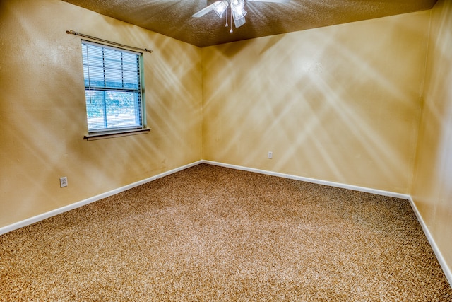 carpeted empty room with a textured ceiling and ceiling fan