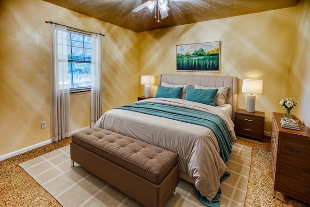 bedroom featuring a textured ceiling, light carpet, and ceiling fan