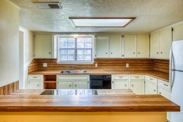 kitchen featuring white refrigerator, sink, a textured ceiling, dishwasher, and decorative backsplash