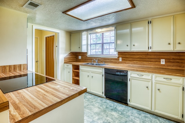 kitchen featuring sink, a textured ceiling, black appliances, decorative backsplash, and butcher block counters