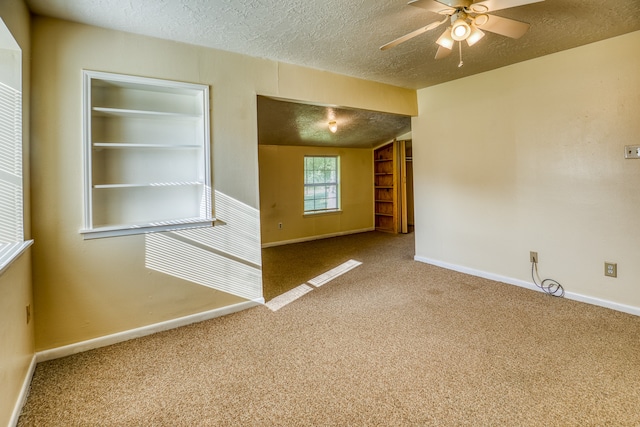 unfurnished room with carpet flooring, a textured ceiling, and ceiling fan