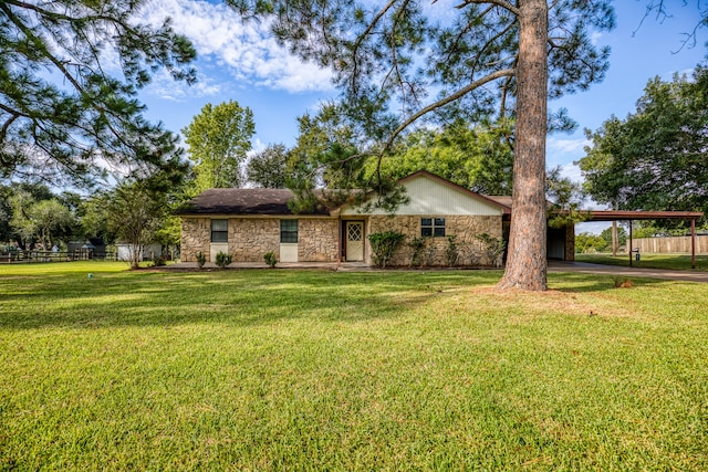 view of front of property with a front yard and a carport