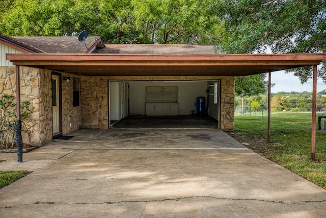 garage featuring a lawn and a carport