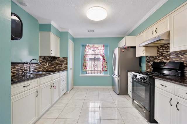 kitchen with a textured ceiling, crown molding, black gas range, dark stone counters, and sink