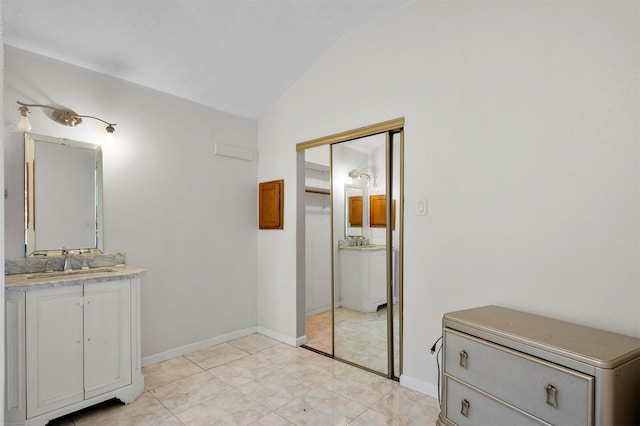 bathroom featuring lofted ceiling, vanity, and tile patterned floors