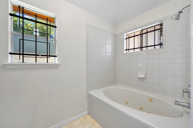 bathroom featuring tiled shower / bath combo and tile patterned flooring