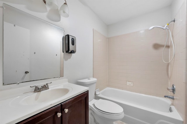 full bathroom featuring tiled shower / bath, vanity, and toilet