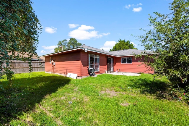 back of house with a yard and a patio area