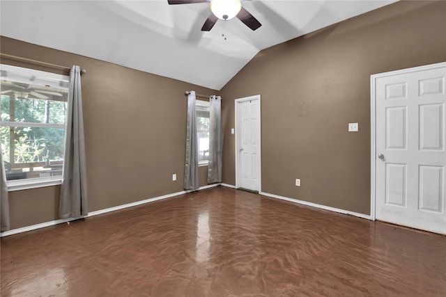 empty room featuring a healthy amount of sunlight, vaulted ceiling, and ceiling fan