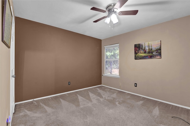 empty room featuring ceiling fan and light colored carpet