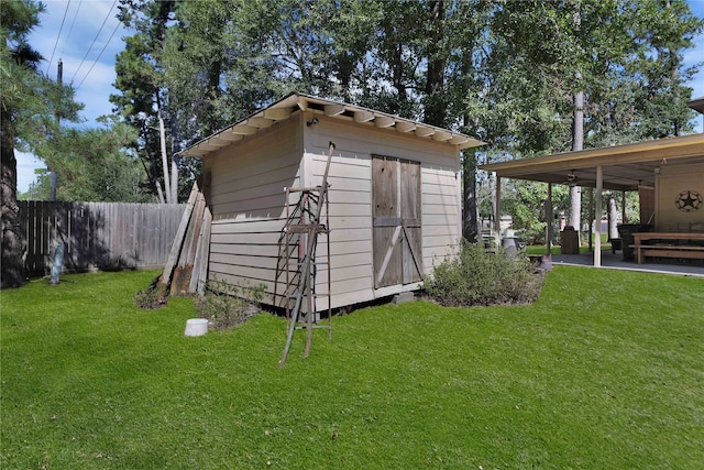 view of outbuilding with a lawn