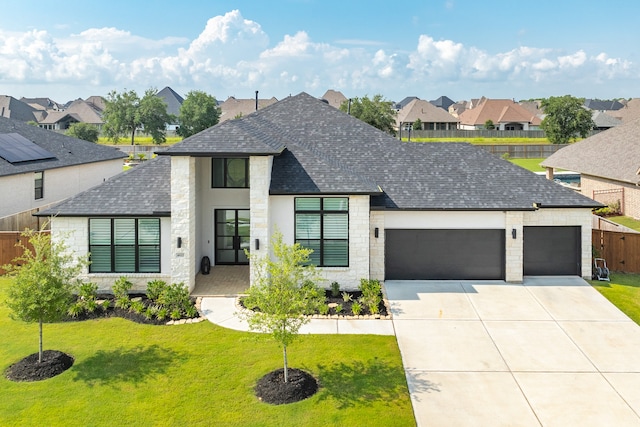 view of front of house with a garage and a front lawn