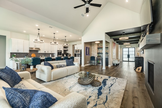 living room featuring dark hardwood / wood-style flooring, ceiling fan, sink, and high vaulted ceiling