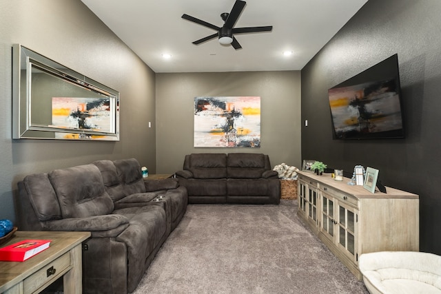 living room with ceiling fan and light colored carpet