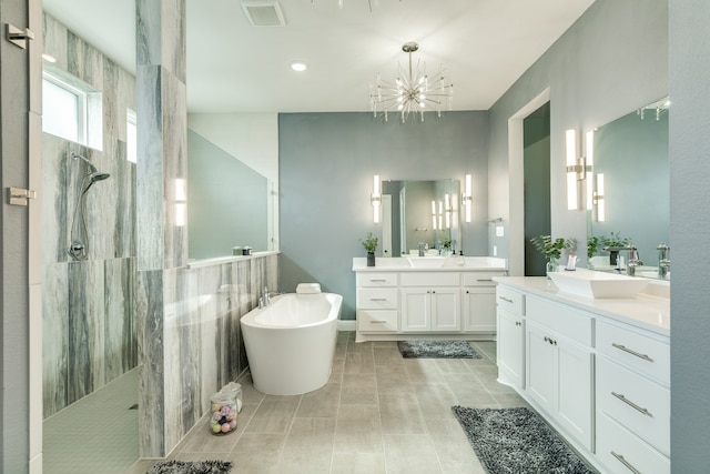 bathroom with a notable chandelier, tile patterned flooring, independent shower and bath, and vanity