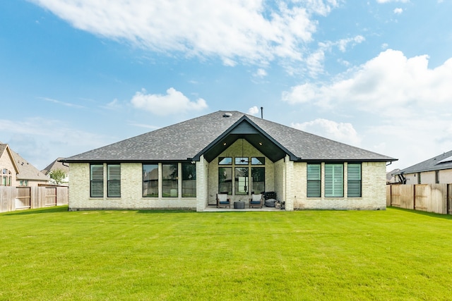 rear view of property with a lawn