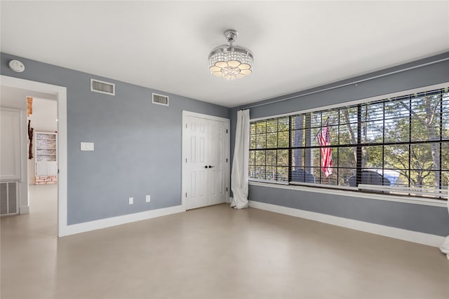 interior space with an inviting chandelier and a closet