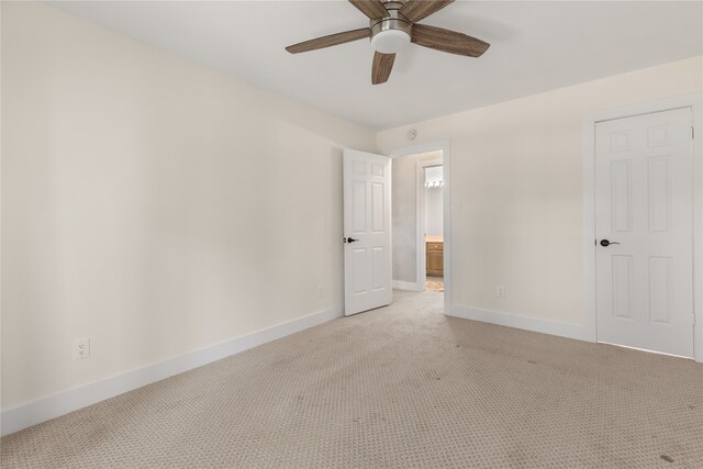 unfurnished room featuring ceiling fan and light colored carpet