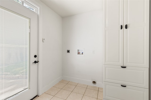 laundry area with cabinets, hookup for an electric dryer, washer hookup, and light tile patterned floors