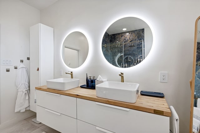 bathroom with vanity, tile patterned floors, and walk in shower