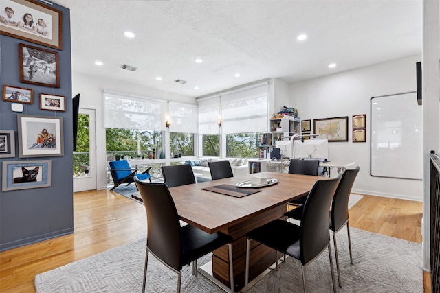 dining space with plenty of natural light and light hardwood / wood-style floors