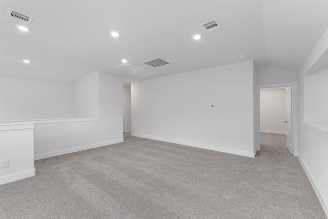 additional living space with lofted ceiling and light carpet