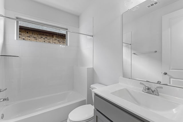 full bathroom with tiled shower / bath, toilet, and vanity