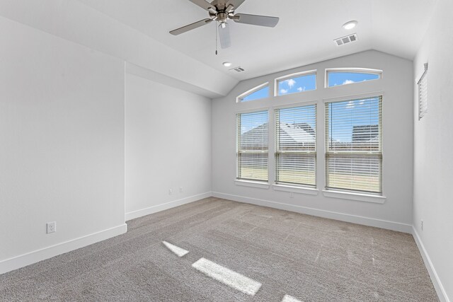 carpeted empty room featuring lofted ceiling and ceiling fan