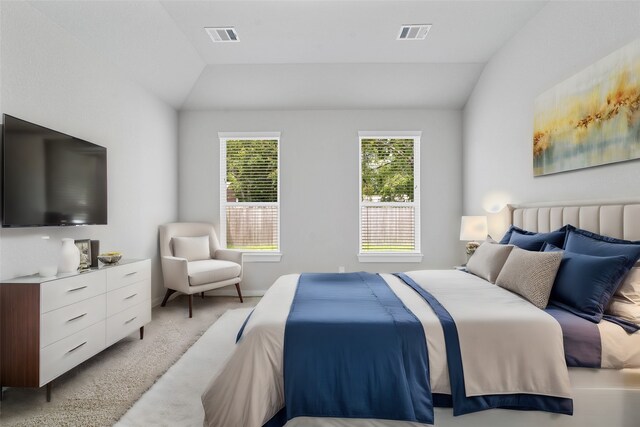 carpeted bedroom with lofted ceiling