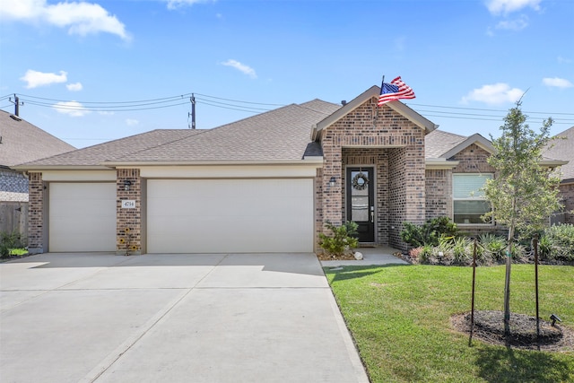 view of front of property featuring a front yard and a garage