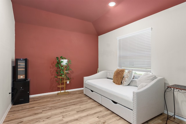 living room with lofted ceiling and light hardwood / wood-style flooring