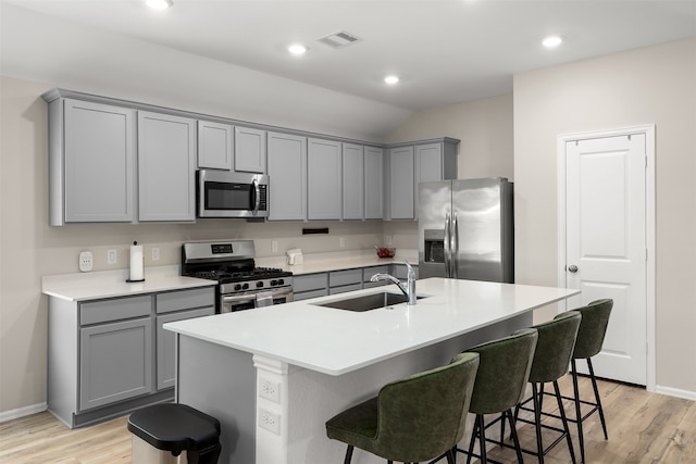 kitchen featuring light hardwood / wood-style floors, a center island with sink, stainless steel appliances, and sink